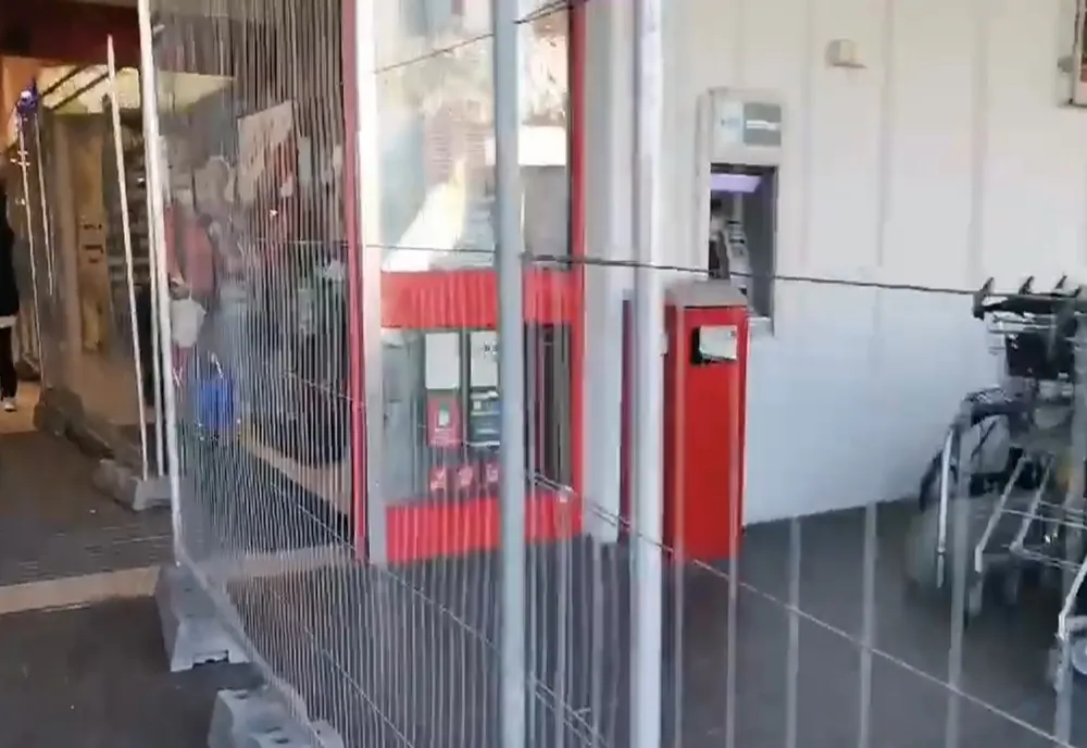 Un gard de sârmă desparte vaccinații de nevaccinați la intrarea într-un supermarket